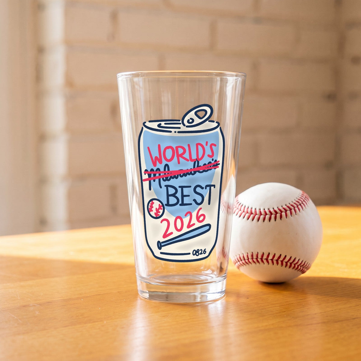 World's Best Pint Glass on a wood table next to a baseball